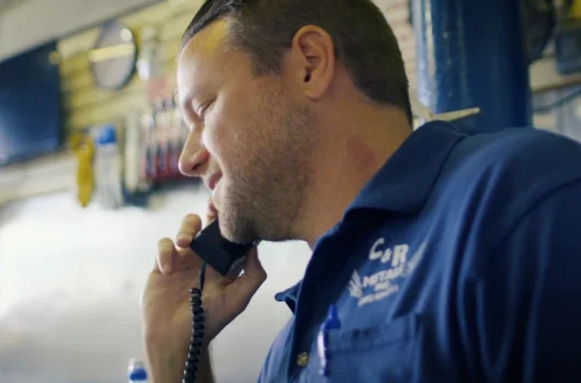 Metals warehouse worker handling customer phone inquiry
